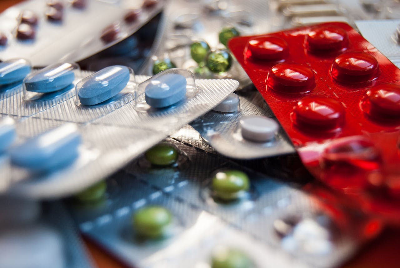 menu-18 Close-up of various colored medication pills in blister packs.