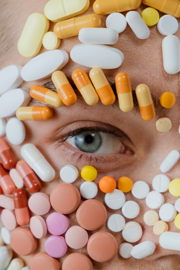 Artistic close-up of a human eye adorned with assorted colorful pills, highlighting modern healthcare themes.