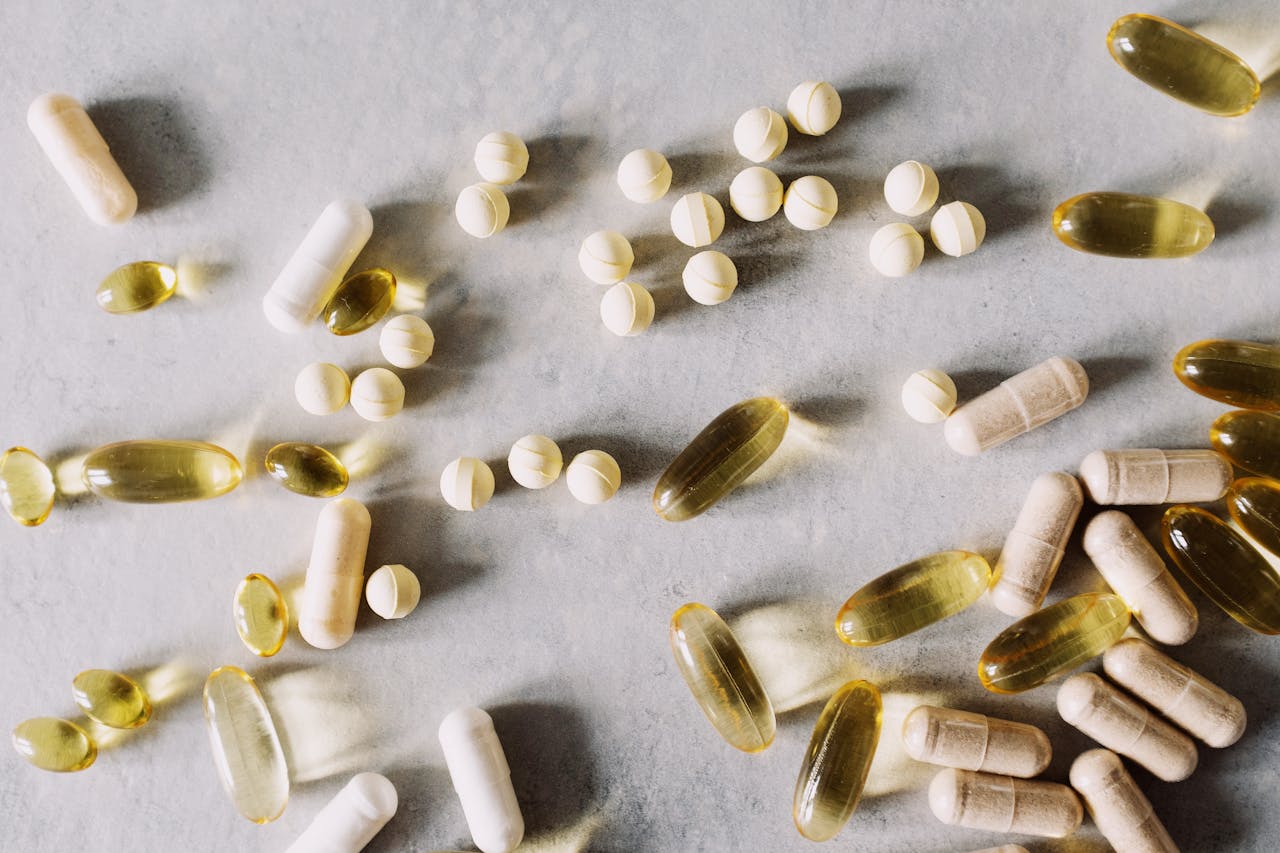menu-08 Top view of scattered set of pills and dietary supplements to prevent lack of vitamins on table in light studio