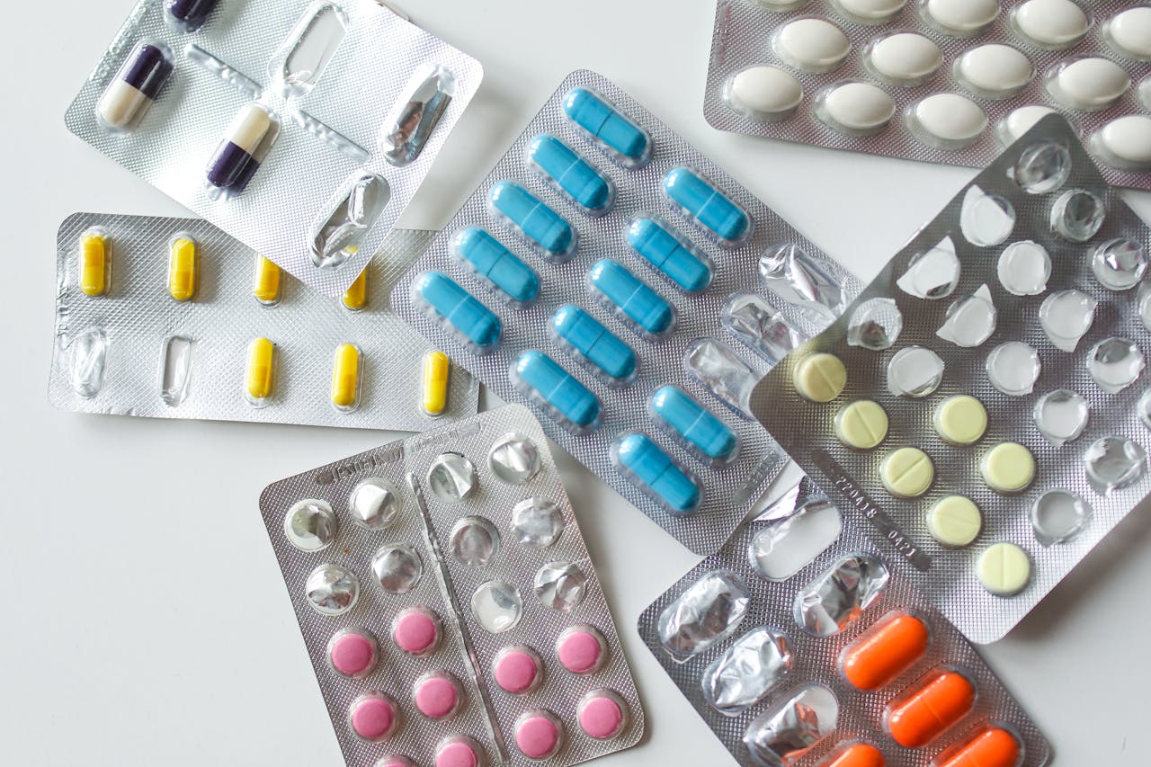 Colorful assortment of pills and capsules in blister packs for healthcare and medication usage.
